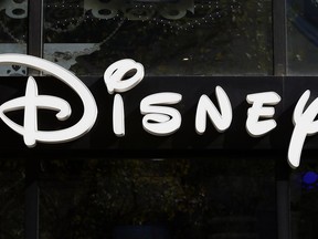 FILE - This Sept. 20, 2017, file photo shows a sign at the Disney store on the Champs Elysees Avenue in Paris, France. The Walt Disney Co. reports earnings Tuesday, Feb. 6, 2018.