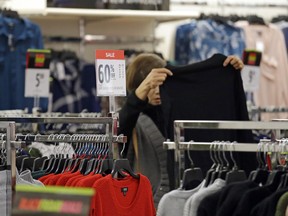 FILE- In this Nov. 24, 2017, file photo, a shopper looks over clothing at a J.C. Penney store in Seattle. On Wednesday, Feb. 14, 2018, the Labor Department reports on U.S. consumer prices for January.