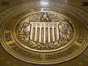 FILE- In this Feb. 5, 2018, file photo, the seal of the Board of Governors of the United States Federal Reserve System is displayed in the ground at the Marriner S. Eccles Federal Reserve Board Building in Washington. The Federal Reserve releases minutes from its January meeting on Wednesday, Feb. 21.