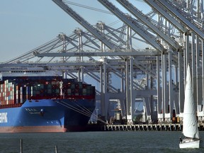 FILE- In this Jan. 30, 2018, file photo, a container ship waits to be unloaded at the Port of Oakland in Oakland, Calif. Economists project that the U.S. economy's rate of growth slowed in the last three months of 2017. On Wednesday, Feb. 28, 2017, the Commerce Department issues the second of three estimates of how the U.S. economy performed in the October-December quarter.