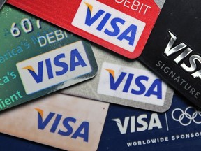 FILE - This Wednesday, June 4, 2014, file photo shows a selection of Visa cards in Boston. Visa Inc. reports earnings, Thursday, Feb. 1, 2018.