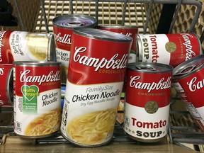 FILE- This May 23, 2017, file photo shows a variety of Campbell's soups in a grocery cart at a store in Phoenix. Campbell Soup Company reports financial results Friday, Feb. 16, 2018.