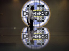 FILE - In this Thursday, Dec. 18, 2014, file photograph, a man looks back at the Merck logo on a stained glass panel at a Merck company building in Kenilworth, N.J. Merck & Company, Inc. reports earnings, Friday, Feb. 2, 2018.