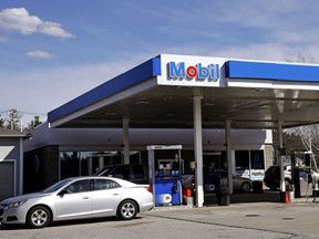 In this Monday, April 24, 2017, photo, a car drives away from a Mobil gasoline station in Londonderry, N.H. Exxon Mobil Corp. reports earnings Friday, Feb. 2, 2018.