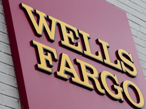 FILE - This Friday, Aug. 11, 2017, file photo shows a sign at a Wells Fargo bank location in Philadelphia. The Fed announced late Friday, Feb. 2, 2018, which was also Fed Chair Janet Yellen's last day, that it was freezing Wells Fargo's growth until it can prove it has improved its internal controls. The company's stock slid more than 6 percent in Friday after-hours trading following the news, and are now down more than 9 percent in Monday premarket trading.