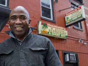 In this Wednesday, Jan. 24, 2018, photo, Amara Sumah, owner of Sumah's West African Restaurant, poses outside the restaurant in the Shaw neighborhood of Washington. Twenty-five years ago, Sumah and his wife, Isata, immigrated from Sierra Leone. They have a successful family-owned business in Washington.