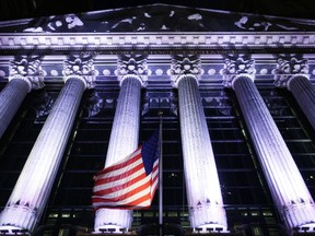 FILE - In this Oct. 8, 2014, file photo, an American flag flies in front of the New York Stock Exchange in New York. The U.S. stock market opens at 9:30 a.m. EST on Thursday, Feb. 22, 2018.