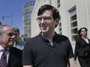 FILE - In this Aug. 4, 2017 file photo, Martin Shkreli, center, leaves federal court in New York. A judge has ruled that "Pharma Bro" Martin Shkreli was responsible for nearly $10.5 million in losses in his securities fraud case. The amount set on Monday by Judge Kiyo Matsumoto could result in a harsher punishment for Shkreli at his March 9 sentencing.