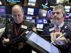 Traders Gordon Charlop, left, and John Panin work on the floor of the New York Stock Exchange, Tuesday, Feb. 6, 2018. The Dow Jones industrial average fell as much as 500 points in early trading, bringing the index down 10 percent from the record high it reached on Jan. 26. The DJIA quickly recovered much of that loss.