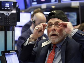 Trader Peter Tuchman works on the floor of the New York Stock Exchange, Monday, Feb. 5, 2018. The Dow Jones industrial average plunged more than 1,100 points Monday as stocks took their worst loss in six and a half years.