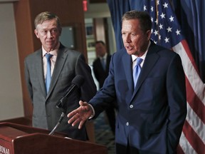 FILE - In this June 27, 2017, file photo, Ohio Gov. John Kasich, right, joined by Colorado Gov. John Hickenlooper, left, speaks during a news conference at the National Press Club in Washington. Kasich, a Republican, and Hickenlooper, a Democrat, scheduled a Friday, Feb. 23, 2018, news conference in Washington to outline their latest bipartisan policy work for improving the nation's health care system.