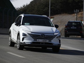 In this Monday, Feb. 12, 2018, photo, Hyundai's autonomous fuel cell electric vehicle Nexo is driven along a road near the Pyeongchang Olympic Stadium in Pyeongchang, South Korea. At Pyeongchang Winter Olympic Games, there are two futures of self-driving vehicles in two different Olympic venues by two different companies. In a reminder of a proxy war between automakers and tech companies, Hyundai and KT have negotiated over the exclusive right to use the buzzword.