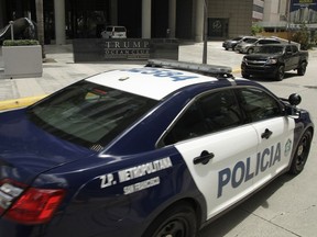 A Panamanian police car passes in front the Trump Ocean Club International Hotel and Tower in Panama City, Tuesday, Feb. 27, 2018. Panama's government is formally investigating a complaint that executives for President Donald Trump's family hotel business are refusing to physically leave the 70-story luxury Trump hotel there amid a management dispute.
