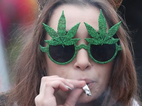 A woman smokes marijuana on Parliament Hill.