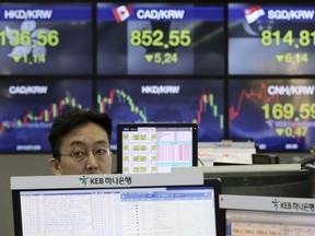 A currency trader works at the foreign exchange dealing room of the KEB Hana Bank headquarters in Seoul, South Korea, Monday, Feb. 19, 2018. Asian markets were higher on Monday following Wall Street gains last week, as market jitters showed signs of easing. Many major markets were closed on holidays.