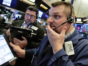 Traders at the New York Stock Exchange react to losses Thursday.