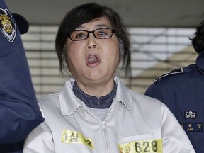 FILE - In this Jan. 25, 2017, file photo, Choi Soon-sil, the jailed confidante of impeached South Korean President Park Geun-hye, shouts upon her arrival at the office of the independent counsel in Seoul, South Korea. A South Korean court is set to deliver a verdict Tuesday, Feb. 13, 2018 in the case of the woman at the center of an influence-peddling scandal that triggered the country's first presidential impeachment and the conviction of an heir to the Samsung empire.