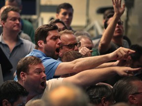 Traders signal offers in the S&P options pit at the Cboe Global Markets, Inc. exchange on February 6, 2018 in Chicago, Illinois.