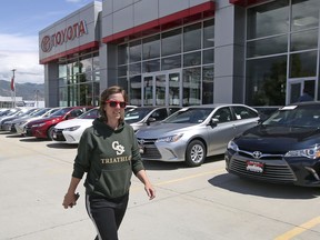 In this Tuesday, June 13, 2017, photo, customer Mary Jean Jones looks for a vehicle at Mark Miller Toyota in Salt Lake City. January 2018 U.S. auto sales are expected to grow just a little as rebates and other deals wane after a December buying spree.