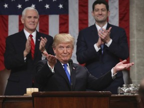 FILE - In this Jan. 30, 2018, file photo, President Donald Trump gestures as delivers his first State of the Union address in the House chamber of the U.S. Capitol to a joint session of Congress in Washington, as Vice President Mike Pence and House Speaker Paul Ryan applaud. Less than a week ago, Trump stood before the nation and called for a new era of bipartisan cooperation. "Tonight, I call upon all of us to set aside our differences, to seek out common ground, and to summon the unity we need to deliver for the people we were elected to serve," he said, extolling how the country had come together in recent times of tragedy. A week later, such talk is but a distant memory.