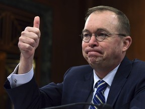 In this Feb. 13, 2018, photo, budget director Mick Mulvaney testifies before the Senate Budget Committee on Capitol Hill in Washington. The Trump administration is pushing a "bold new approach to nutrition assistance: " Replacing the traditional cash on a card that food stamp recipients currently get with a pre-assembled box of canned foods and other shelf-stable goods dubbed "America's Harvest Box." Mulvaney likened the box to a meal kit delivery service, and said the plan could save nearly $130 billion over ten years.  The idea, tucked into President Donald Trump's 2019 budget, has caused a firestorm, prompting scathing criticism from Democrats and food insecurity experts who say its primary purpose is to punish the poor.