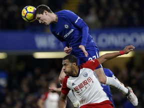Chelsea's Andreas Christensen, top, heads the ball clear under pressure from West Bromwich Albion's Salomon Rondon during the English Premier League soccer match between Chelsea and West Bromwich Albion at Stamford Bridge stadium in London, Monday, Feb. 12, 2018.