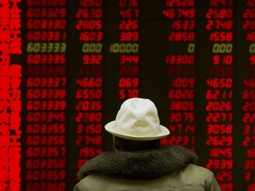 A Chinese investor monitors stock prices at a brokerage house in Beijing, Monday, Feb. 12, 2018. Asian stock markets are mostly higher after Wall Street gained following a week of history-making losses.