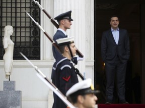 Greek Prime Minister Alexis Tsipras waits for the arrival of the Irish President Michael D. Higgins during a welcome ceremony at Maximos Mansion in Athens, Thursday, Feb. 22, 2018. Moody's ratings agency upgraded Greece's credit rating by two notches late Wednesday to B3, saying the country is set to return to market-based funding following the conclusion of its current bailout program in the summer.
