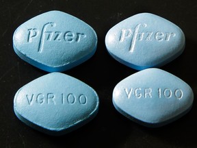 Counterfeit Viagra pills, top and bottom left, are displayed alongside real ones, top and bottom right.