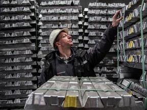 A worker inspects bound aluminum ingots stacked in a warehouse ahead of shipping at the Alumetal Group Hungary Kft. aluminum processing plant in Komarom, Hungary.