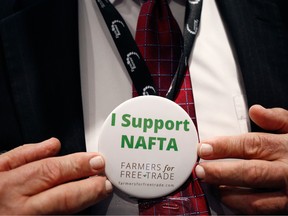 An attendee displays an "I Support NAFTA" button for a photograph during the annual American Farm Bureau Federation conference in Nashville, Tennessee, U.S., on Monday, Jan. 8, 2018.