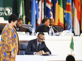 Rwanda's President Paul Kagame, who is also the current chairman of the African Union, signs the African Continental Free Trade Area (CFTA) Agreement during the 10th Extraordinary Session of the African Union (AU) in Kigali, Rwanda, Wednesday, March 21, 2018. African leaders on Wednesday signed what is being called the largest free trade agreement since the creation of the World Trade Organization.
