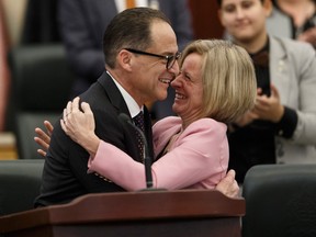 Alberta Finance Minister Joe Ceci hugs Premier Rachel Notley after delivering Budget 2018 in the Alberta Legislature.