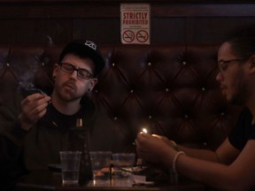 In this March 1, 2018 photo, Rick Thompson, left, and Keith Baskerville smoke marijuana in the smoking lounge at Barbary Coast Dispensary in San Francisco. San Francisco plans to issue more permits for marijuana smoking lounges this year after health officials finalize updated regulations.
