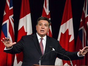 Ontario Finance Minister Charles Sousa speaks to reporters in Queens Park in Toronto on Tuesday, November 14, 2017. Ontario's Liberal government will present its final budget today before voters head to the polls in early June.