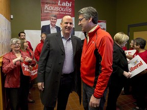 Nova Scotia Liberal Leader Stephen McNeil, right, chats with Labi Kousoulis, in Halifax on Monday, Oct. 7, 2013. Nova Scotia employers would have to provide up to 16 continuous weeks of unpaid leave for employees who are victims of domestic violence under proposed legislation.