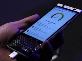 A man holds the new BlackBerry KEYone before the Mobile World Congress in Barcelona, Spain, Saturday, Feb. 25, 2017. BlackBerry Ltd.'s revenue and adjusted earnings came in above analyst estimates in its fourth quarter, as all three of the company's main software divisions showed growth.