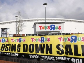 Toys R Us says it's business as usual at its Canadian stores, even as it announced it would close the retailer's remaining U.K. locations. A branch of Toys R Us at St Andrews retail park displays a closing down sale banner, in Birmingham, England, on Feb. 27, 2018.