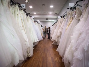 Women browse wedding dresses for sale at the Original Bridal Swap at the Croatian Cultural Centre in Vancouver, B.C., on Sunday April 3, 2016.