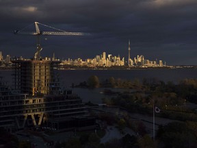 Condominiums are seen under construction in front of the skyline in Toronto, Ont., on Tuesday October 31, 2017. Canada's largest real estate board says home sales in the Greater Toronto Area fell nearly 35 per cent year-over-year in February, as selling prices dropped more than 12 per cent.