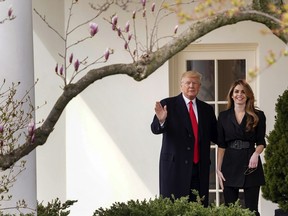 President Donald Trump waves with outgoing White House Communications Director Hope Hicks before boarding Marine One on the South Lawn of the White House in Washington, Thursday, March 29, 2018, for a short trip to Andrews Air Force Base, Md., and then on to Cleveland.