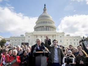 Senate Minority Leader Sen. Chuck Schumer, D-N.Y., holds hands with student activist Matt Post of Md., right, during a student gun control advocates rally outside the Capitol Building in Washington, Wednesday, March 14, 2018. Students walked out of school to protest gun violence in the biggest demonstration yet of the student activism that has emerged in response to last month's massacre of 17 people at Florida's Marjory Stoneman Douglas High School.