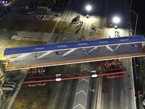 This March 10, 2018 photo shows an early morning view of the main span of the a pedestrian bridge that is being positioned to connect the City of Sweetwater, Fla., to Florida International University near Miami. The 950- ton new bridge collapsed Thursday, March 15,  over several cars causing several fatalities and injuries.