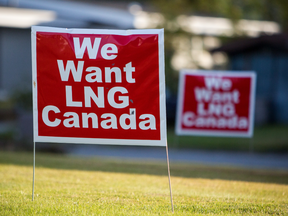 Signs reading "We Want LNG Canada" stand on a lawn in the residential area of Kitimat, B.C. LNG Canada's export terminal would be built in the community if the project gets the okay.