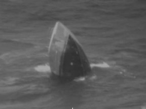 In this image provided by the U.S. Coast Guard, the commercial longline fishing vessel Princess Hawaii sinks about 400 miles north of the Big Island on Sunday, March 25, 2018. Eight people, including the crew, captain and a federal fishery observer abandoned the ship and escaped in a life raft. A Coast Guard air crew dropped a radio to the life raft and helped establish communication with the vessel's sister ship, the Commander, which was fishing nearby and came to rescue the survivors.