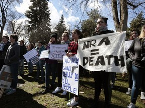 Protesters hold signs while listening to speakers at a March For Our Lives rally, Saturday, March 24, 2018, in Moscow, Idaho.