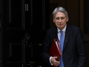 Britain's Chancellor Philip Hammond leaves 11 Downing Street to deliver his Spring Statement in Parliament, in London, Tuesday, March 13, 2018.