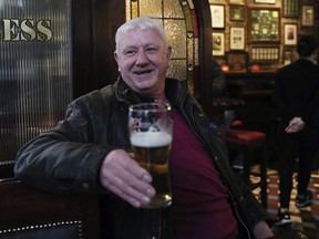 Jim Croke, in Slattery's Bar on Capel Street in Dublin, drinks a pint on Good Friday, Friday March 30, 2018. Drinking establishments are open and serving alcohol _ thanks to recently legislation that overturned a ban in place since 1927 and took effect in the nick of time for thirsty locals and tourists.