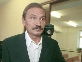 FILE - In this Tuesday, Dec. 19, 2000 file photo, ex-deputy director general of Aeroflot airlines company Nikolai Glushkov leaves the Lefortovsky court escorted by police officers, after the judge refused to release him on bail, in Moscow. British police say on Friday, March 16, 2018 they are treating the death of London-based Russian businessman Nikolai Glushkov as a homicide, after a post-mortem revealed he died from compression to the neck. Glushkov was an associate of Boris Berezovsky, a Russian oligarch and Kremlin critic who died under disputed circumstances in 2013.