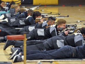 In this March 2, 2018 photo, a group of JROTC shooters compete in the prone position during the 2018 New Mexico Junior Olympic Qualifier for sport and precision air rifles at Cibola High School in Albuquerque, N.M., for the chance to compete at the National Junior Olympic Championships in Ohio in June. The National Rifle Association has given more than $7 million in grants to hundreds of U.S. schools in recent years, typically used for JROTC programs, including $126,000 given to Albuquerque schools.